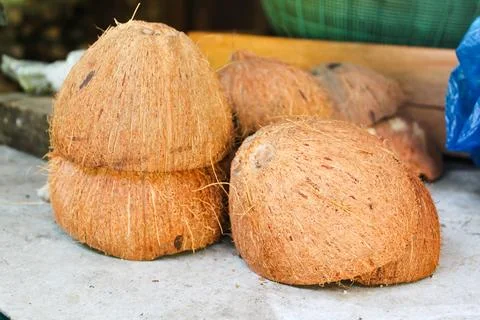 Brown coconut shells stacked on a table Stock Photos