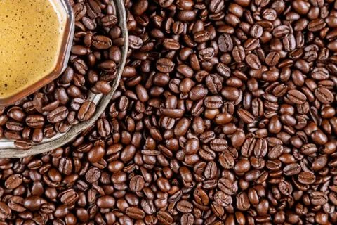 Brown coffee beans a cup of coffee placed on a ready to drink coffee 写真素材