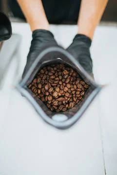 Brown coffee beans in a gray ceramic bowl Stock Photos