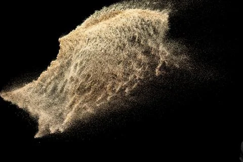 Brown colored sand splash.Dry river sand explosion isolated on black backgr.. Stock Photos