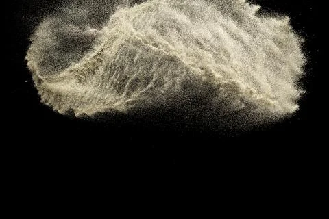 Brown colored sand splash.Dry river sand explosion isolated on black backgr.. Stock Photos