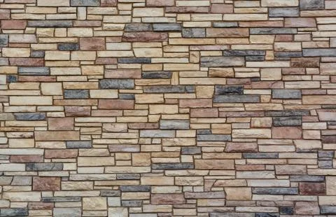 Brown colored stone setting. Cut stone wall texture. Stock Photos