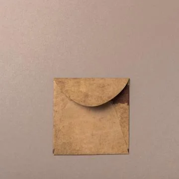 Brown craft envelope on gray background Stock Photos
