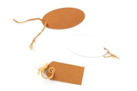 Brown craft paper and white labels. Price tags shot from the top on a white Photos
