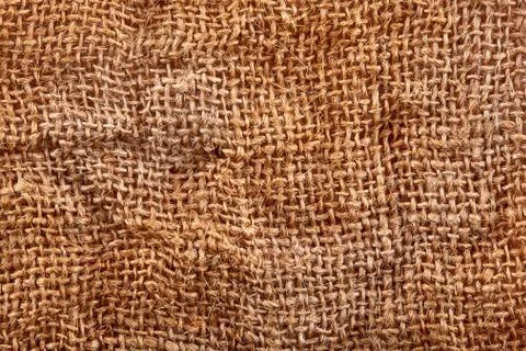 Brown crumpled burlap texture background. Macro of hessian cloth Stock Photos