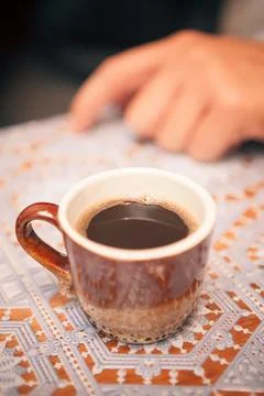 Brown cup of coffee on the table Stock Photos