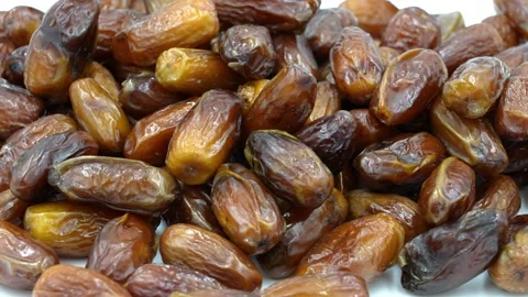 Brown dates on the table Stock Footage 154237268