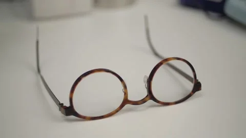 Brown Designer Glasses on Table Stock Footage 148498819