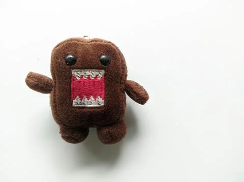 A brown doll with a white background Stock Photos