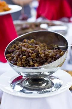 Brown dried grape at the silver cup Foto stock