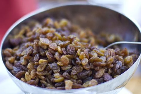 Brown dried grape at the silver cup Stock Photos