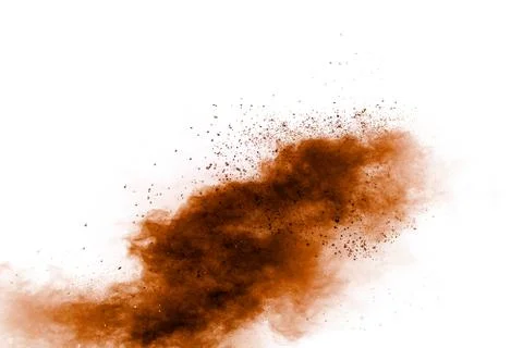 Brown dust exploding cloud.Brown particles splattered on white background. Stock Photos