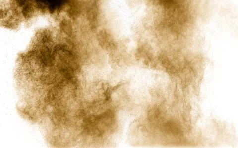 Brown dust explosion cloud.Brown particles splatter on white background. Stock Photos