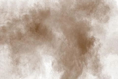 Brown dust explosion cloud.Brown particles splatter on white background. Stock Photos