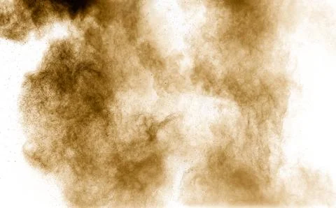 Brown dust explosion cloud.Brown particles splatter on white background. Stock Photos