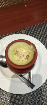 A brown earthen pot with multiple layers and a wide opening at the top. Stock Photos