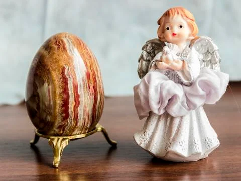 Brown Easter egg with a beautiful little angel Stock Photos