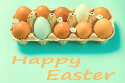 Brown Easter eggs lie in a plate on a blue background Stock Photos