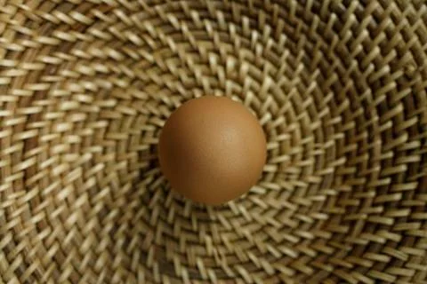Brown egg in basket Stock Photos