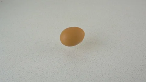 A brown egg falls onto the table and the shell breaks Video stock 116598770