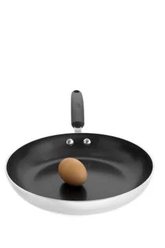 Brown egg in frying pan Stock Photos