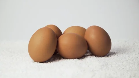 Brown eggs are on the white background Stock Footage 127857413