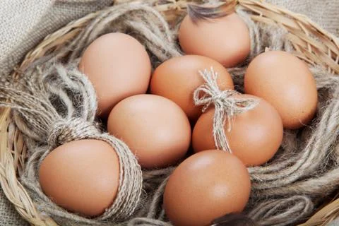 Brown eggs in a basket on the canvas. Stock Photos