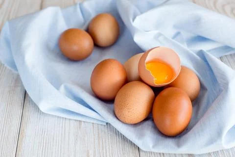 Brown eggs on a blue napkin Stock Photos
