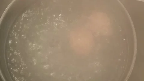 Brown Eggs Boiling Vigorously In Pot Overhead View Stock Footage 320779053