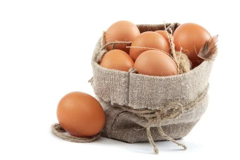Brown eggs in canvas sack isolated on a white background Stock Photos