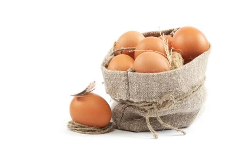 Brown eggs in canvas sack isolated on a white background Stock Photos