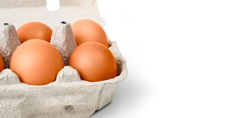 Brown eggs in a cardboard box. Isolated on a white background with a shadow. Stock Photos