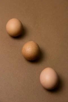 Brown eggs pattern on a brown background Stock Photos