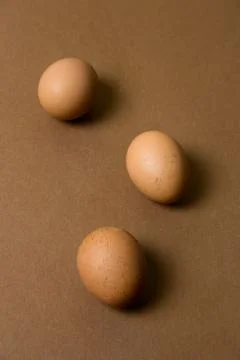 Brown eggs pattern on a brown background Foto stock