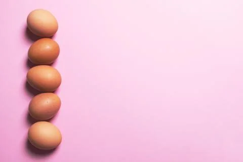 Brown eggs on pink background. Stock-Fotos
