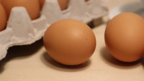 Brown Egg's Placed into Frame by Woman's Hand Vídeos de archivo 128648222