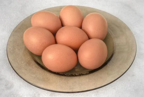 Brown eggs in plate Stock Photos