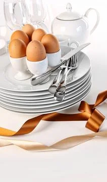 Brown eggs with plates for Easter breakfast Stock Photos