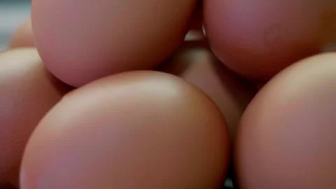 Brown eggs stacked on white surface indoors 스톡 동영상 328481614