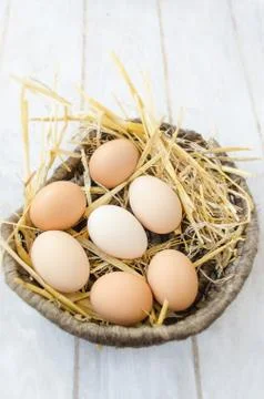 Brown eggs in a wicker basket Stock Photos