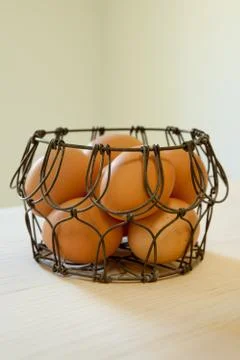 Brown eggs in a wire basket Stock Photos