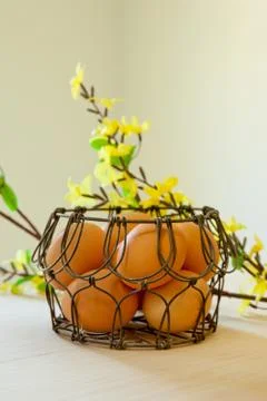 Brown eggs in a wire basket Stock Photos