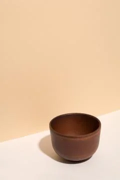 Brown empty cup on pastel background. Stock Photos