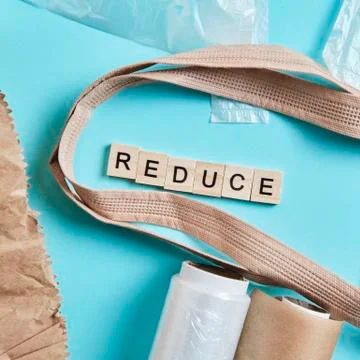 Brown empty Tote Bag next to eco unfriendly pouches and wrap, reducing consumer Stock Photos