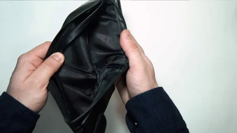 A brown empty wallet with mans hand. The man is looking for money on the wallet Stock Footage 72869435