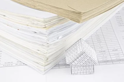 Brown envelope and overload of old paperwork with house Stock Photos