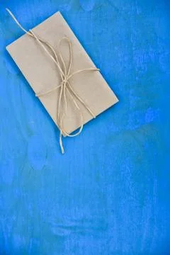 Brown envelope on a blue background. Stock Photos