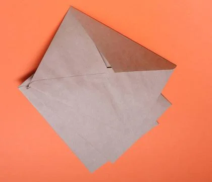 Brown envelops on orange background Brown envelops on bright orange backgr... Stock Photos