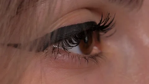 Brown eye looks into the distance. A woman's eye in makeup. Stock Footage 157447528