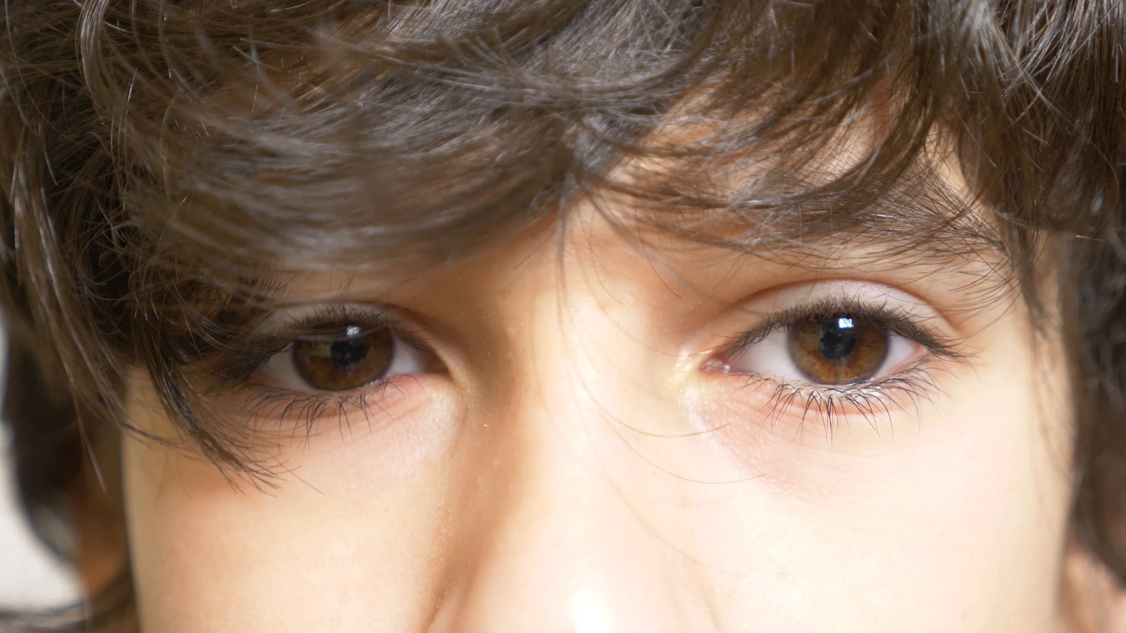 The brown eyes of a boy with long black ... | Stock Video | Pond5